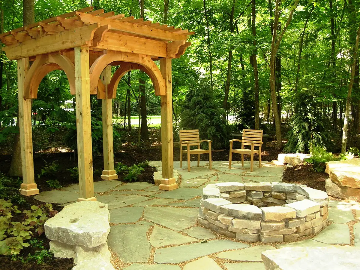 Mohr arbor stone patio with firepit and pergola by Riepenhoff Landscape