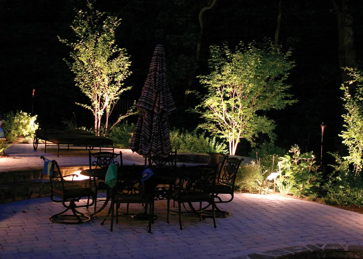 patio-lighting-1 stone patio and landscaping at night by Riepenhoff Landscape